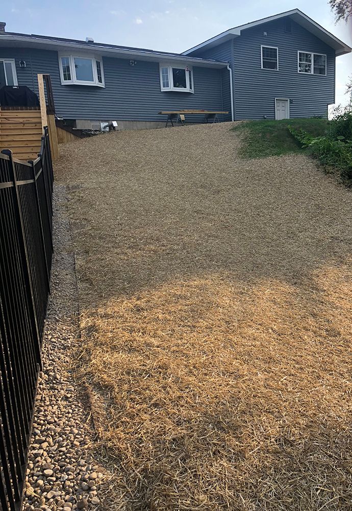 A large house with a gravel driveway in front of it.