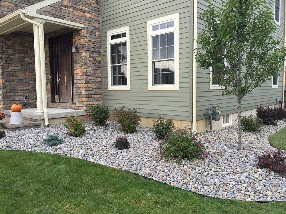 A house with a lot of rocks in front of it.