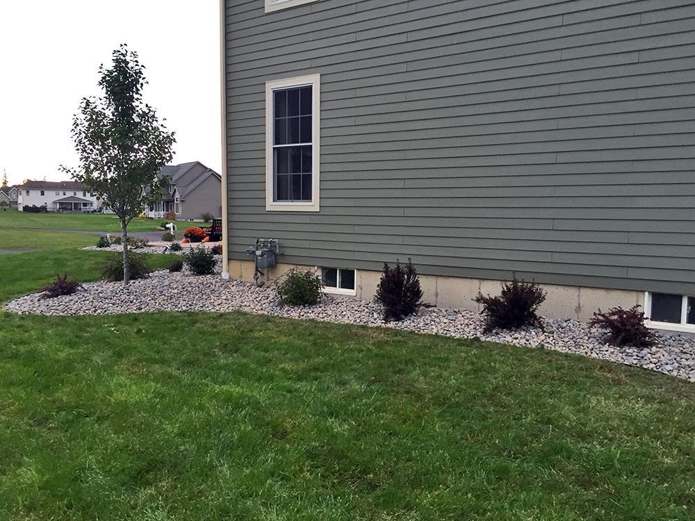 A house with a lush green lawn in front of it