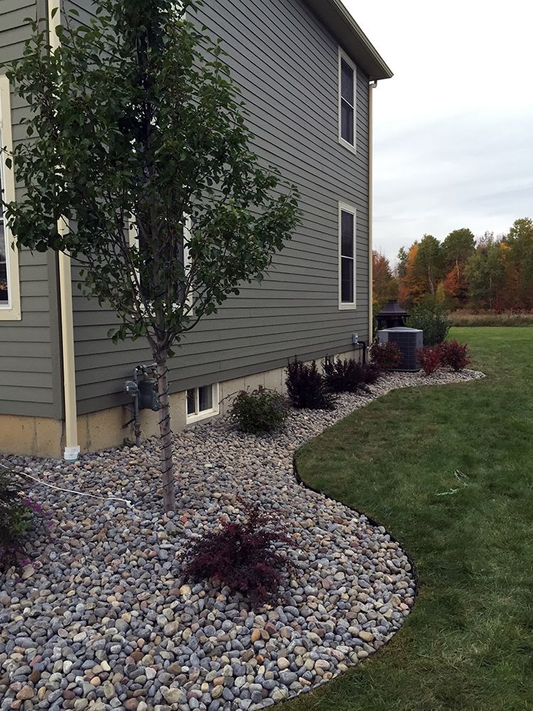 A house with a lot of rocks in front of it