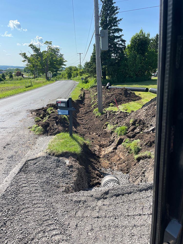 A dirt road with a hole in the middle of it.