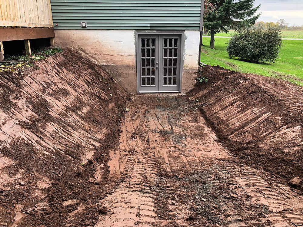 A large pile of dirt is sitting in front of a house.