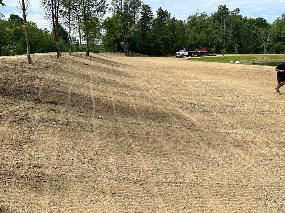 A man is running on a dirt road in a field.