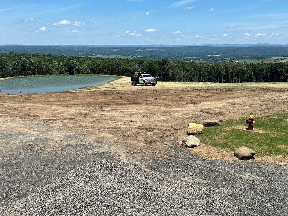 A truck is parked in the middle of a dirt field.