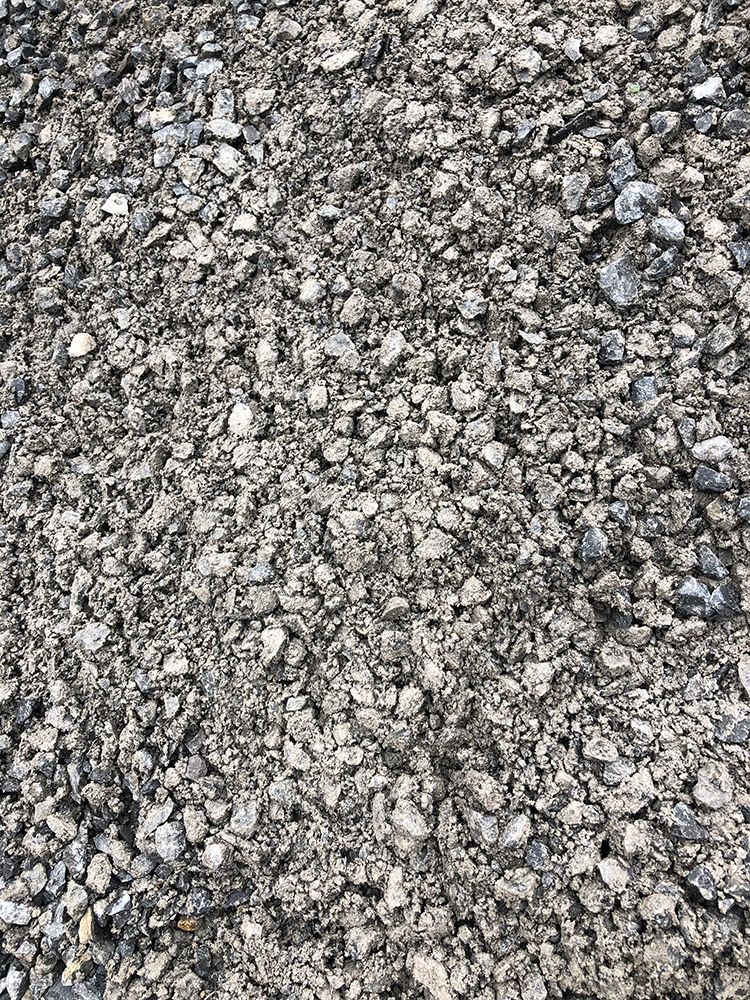 A pile of gravel is sitting on the ground.