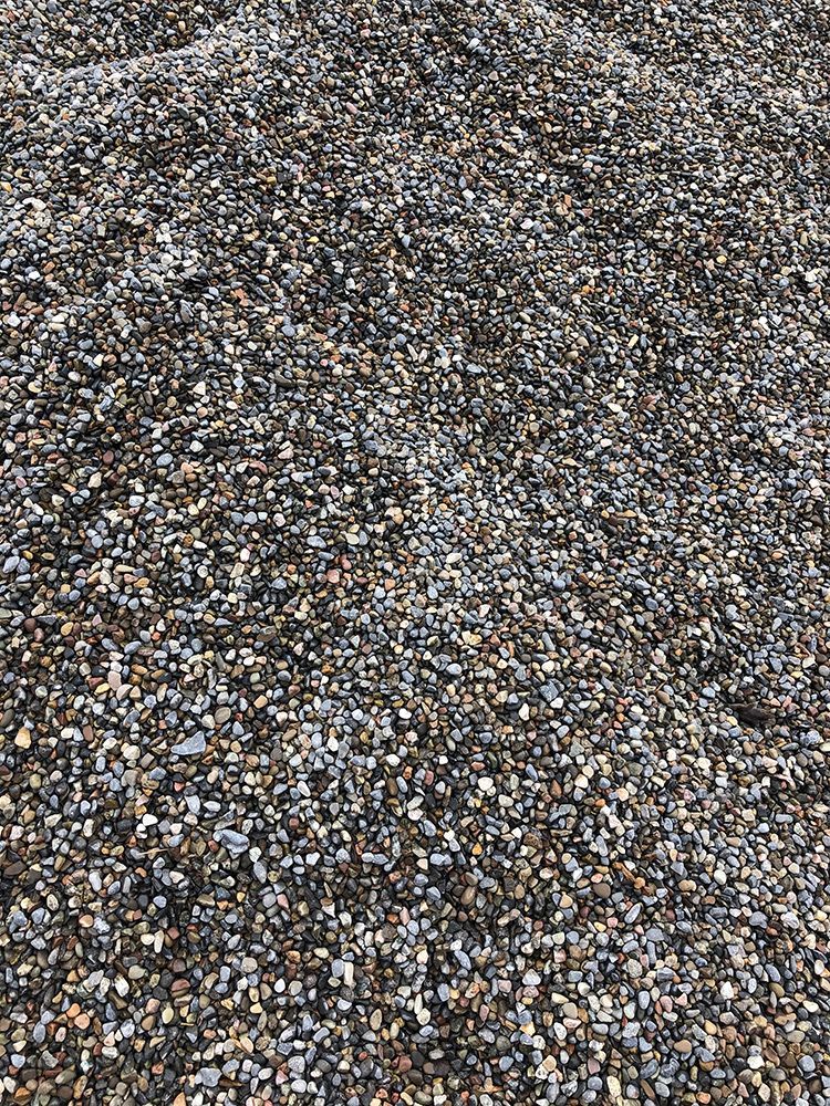 A pile of gravel is sitting on the ground.