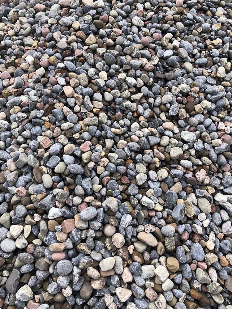 A pile of rocks is sitting on the ground.
