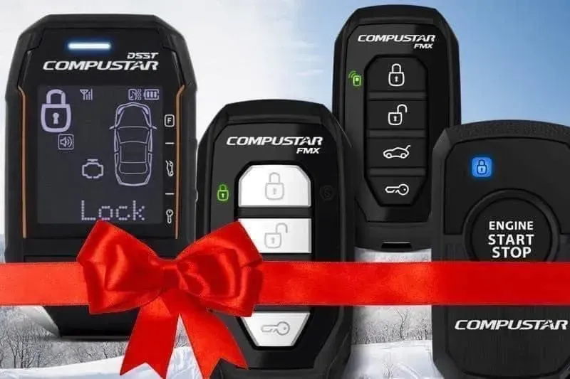 A group of compustar remote controls with a red ribbon.