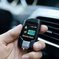 A person is holding a remote start in their hand.