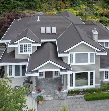 An aerial view of a large house with a dark roof