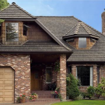 A brick house with a brown garage door