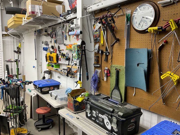 A room filled with lots of tools and a clock on the wall.