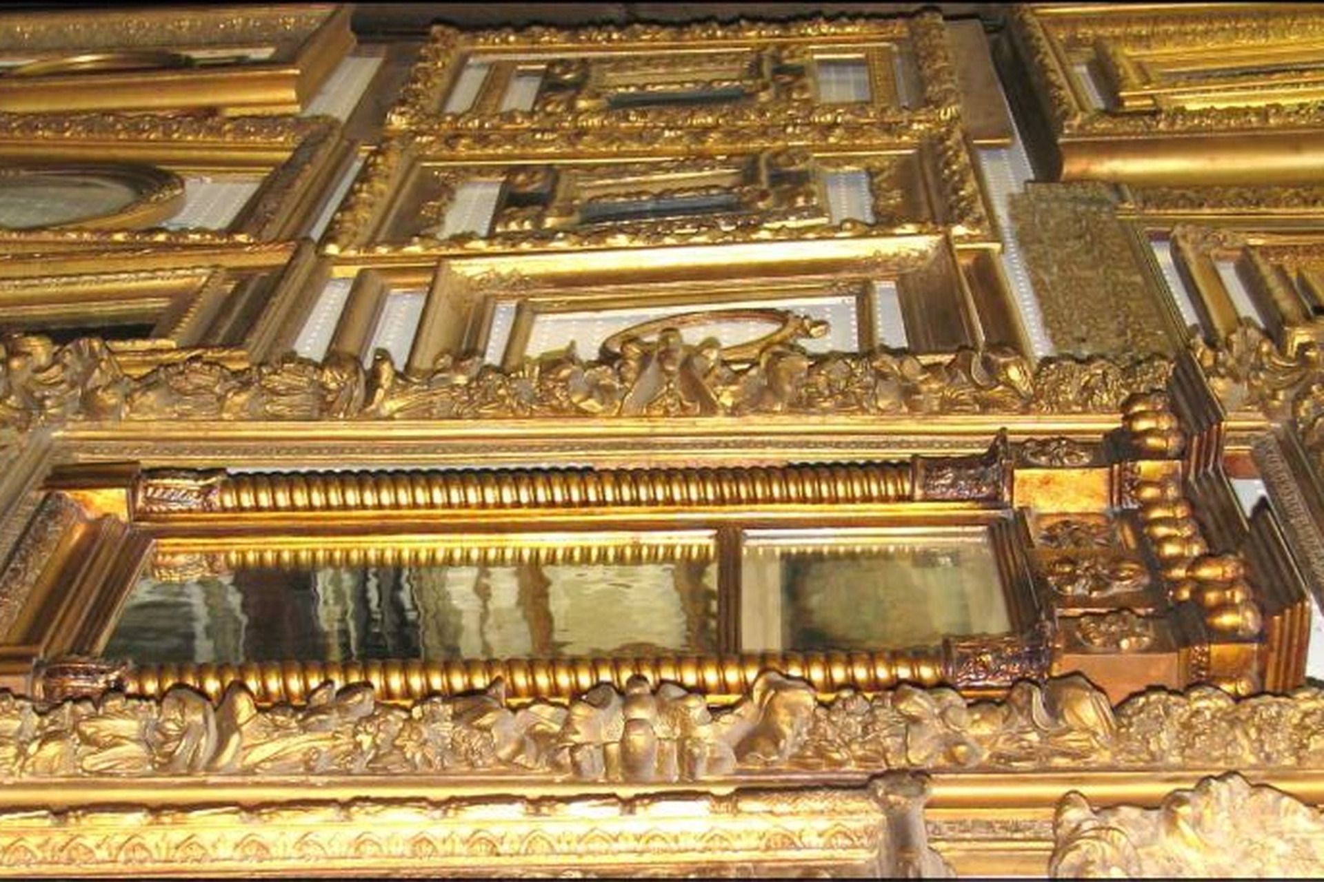 Gold ornate carved architectural detail with framed panels and decorative molding