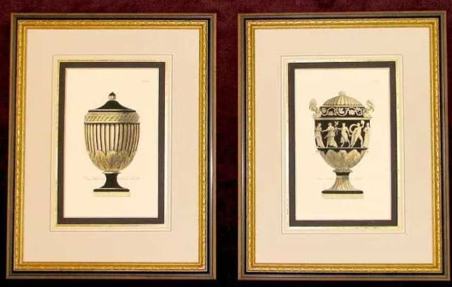 Two framed prints of neoclassical urns featuring black-and-white decorative designs on cream backgrounds.