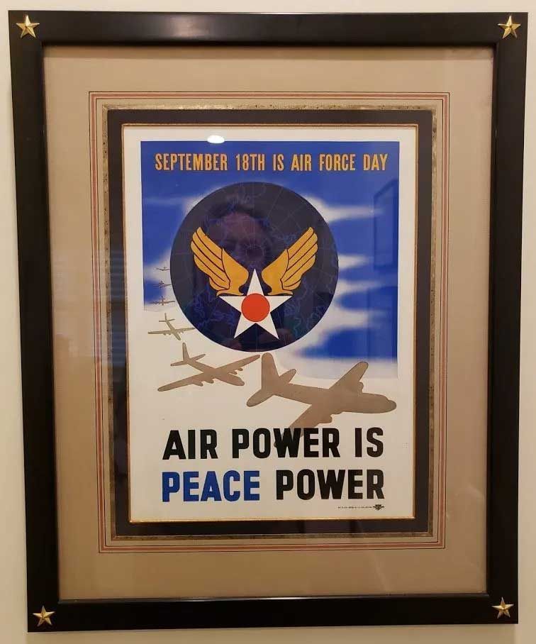 A framed vintage poster reads 