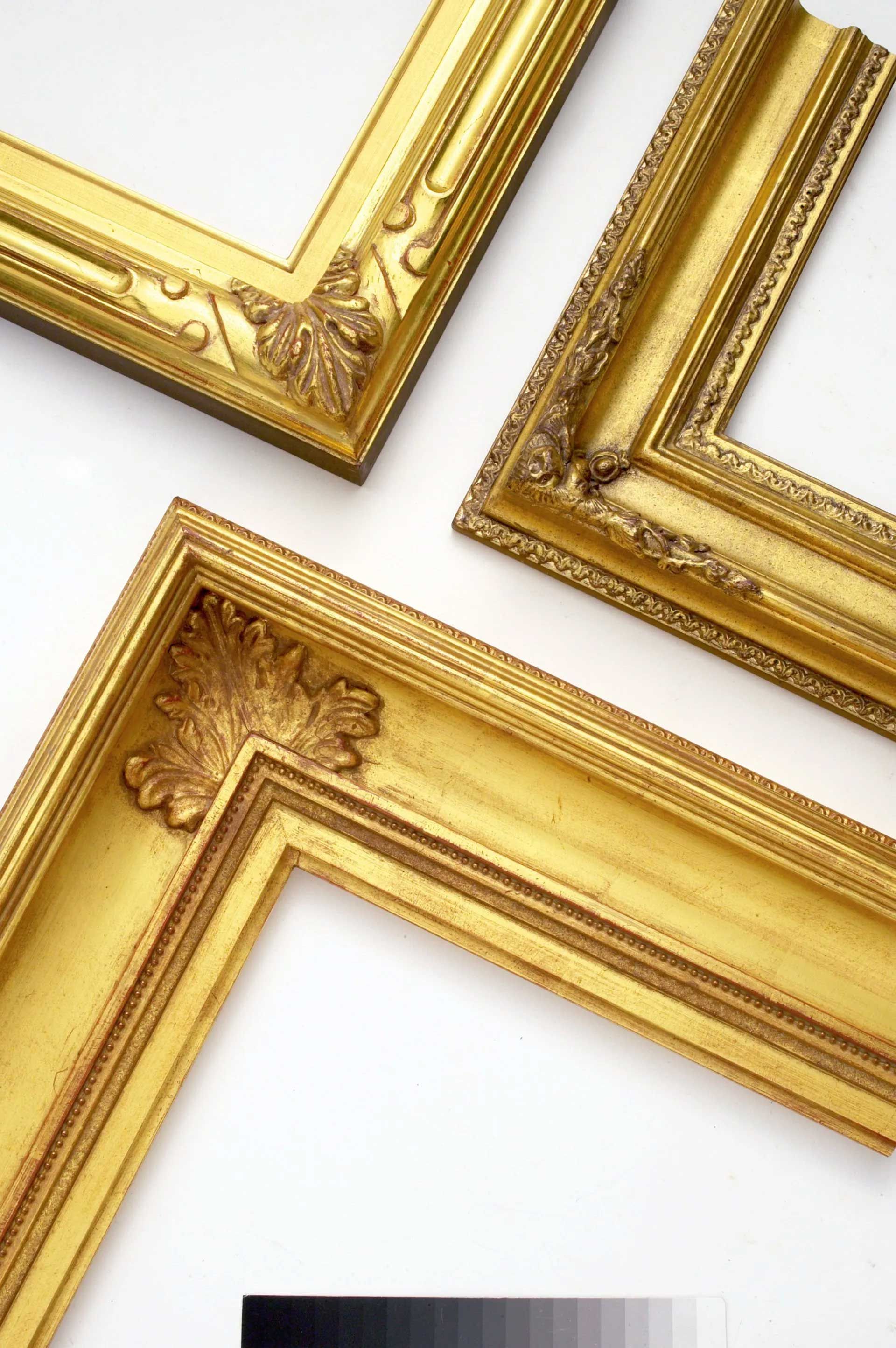 Three ornate, gold-colored picture frames arranged on a white background.
