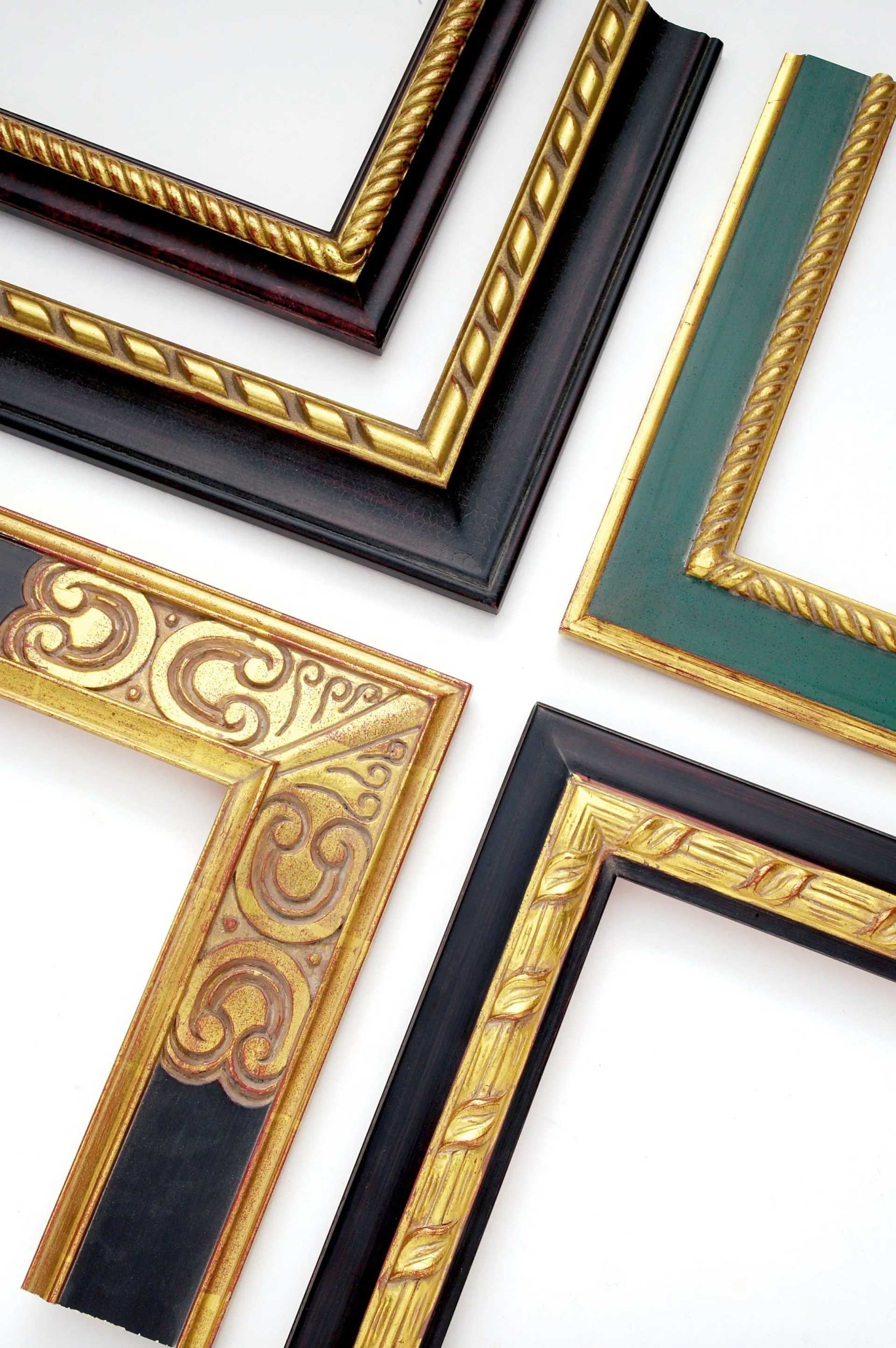 Four varied ornate picture frame corners with gold detailing in black and green finishes, arranged on a white background.