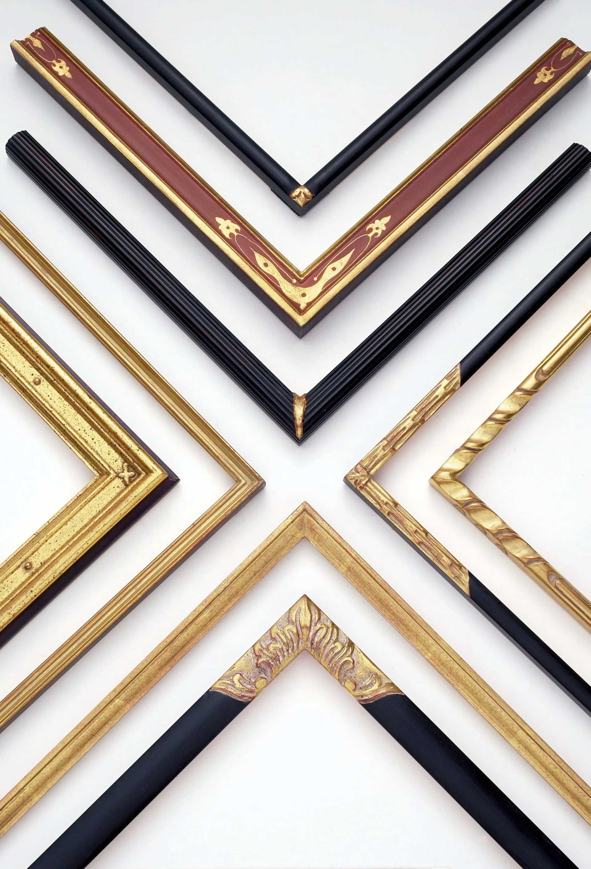 A collection of various ornate picture frame corner samples in gold, black, and red displayed against a white background.