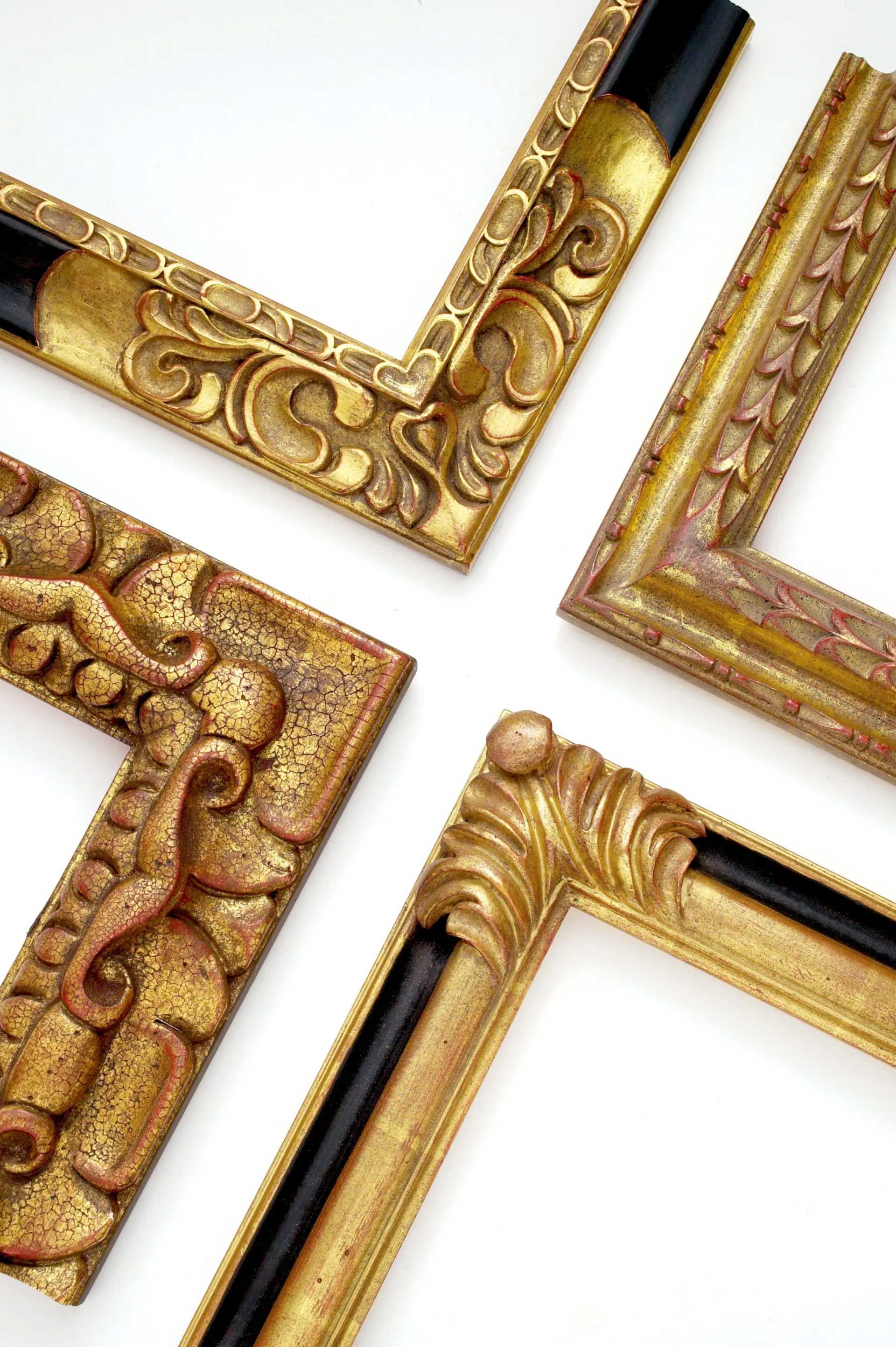 Four ornate, gold-finished picture frame corners with varying decorative carvings arranged against a white background.