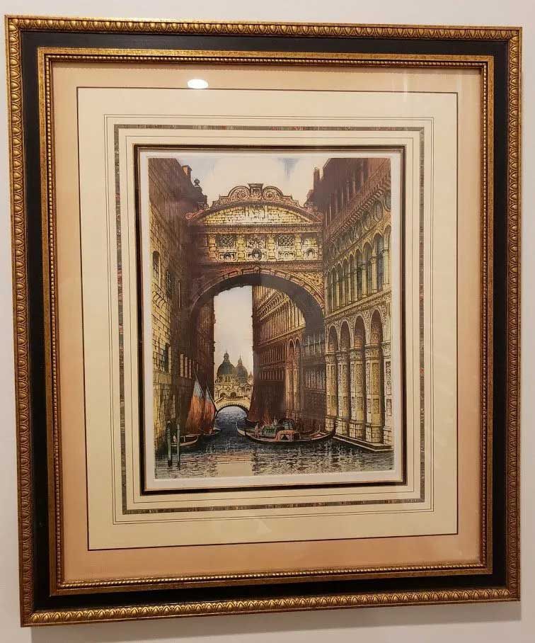 A framed etching of the Bridge of Sighs in Venice, featuring the canal, gondolas, and ornate stone architecture.