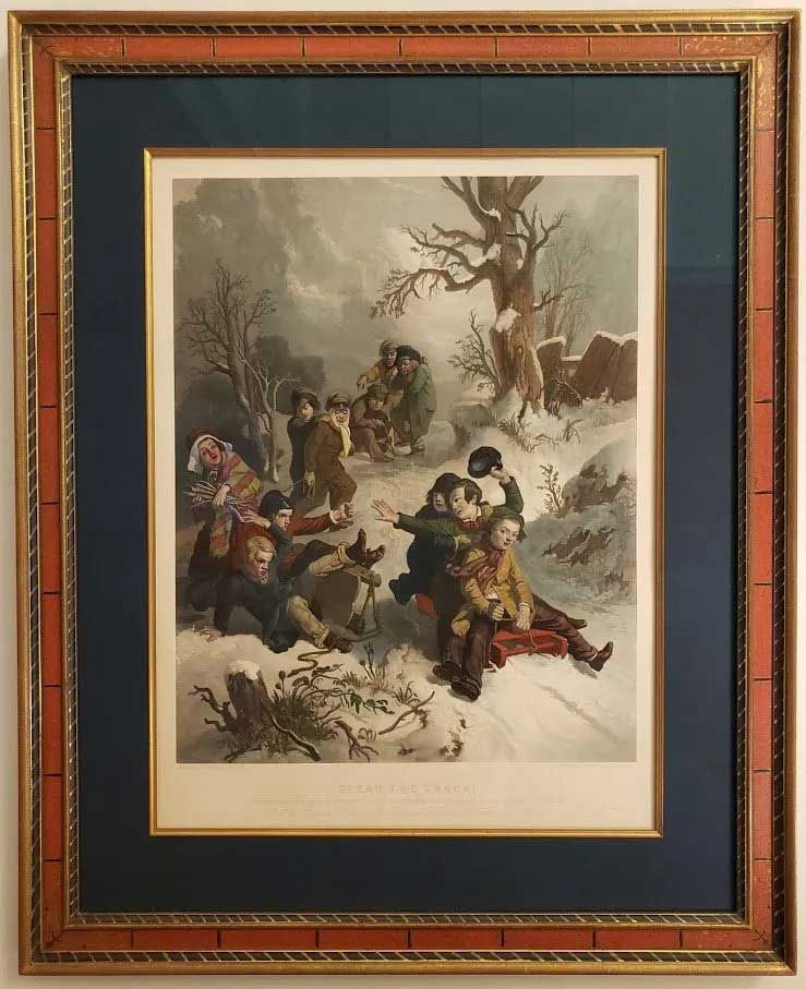 Framed print of children playing in the snow, sledding down a hill, with bare trees and a wintry landscape background.