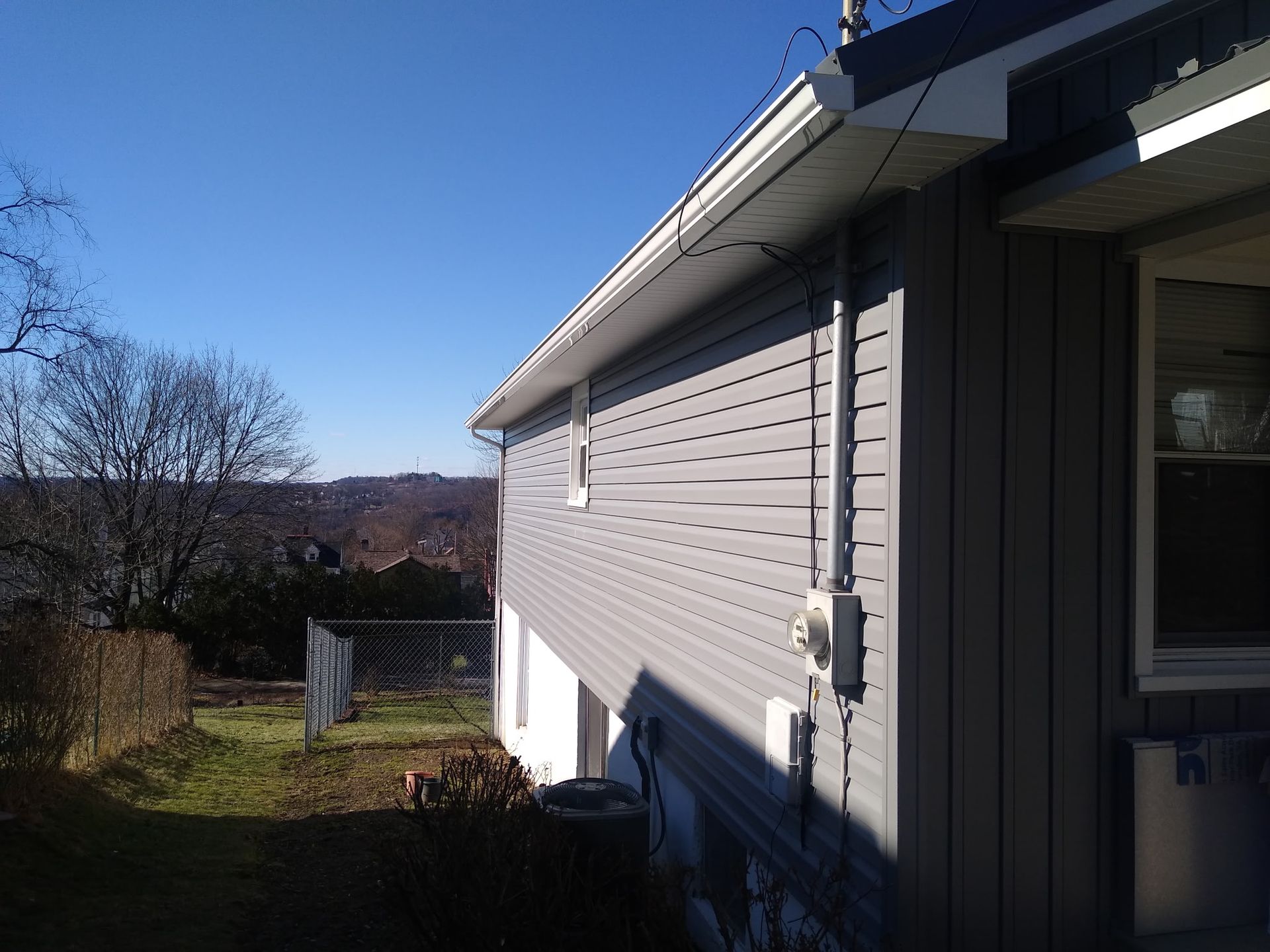 The side of a house with a blue sky in the background