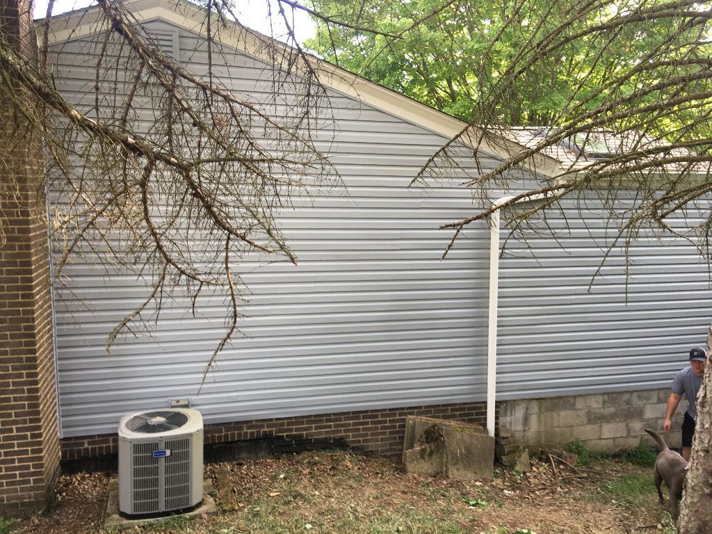 Light grey siding with white gutter