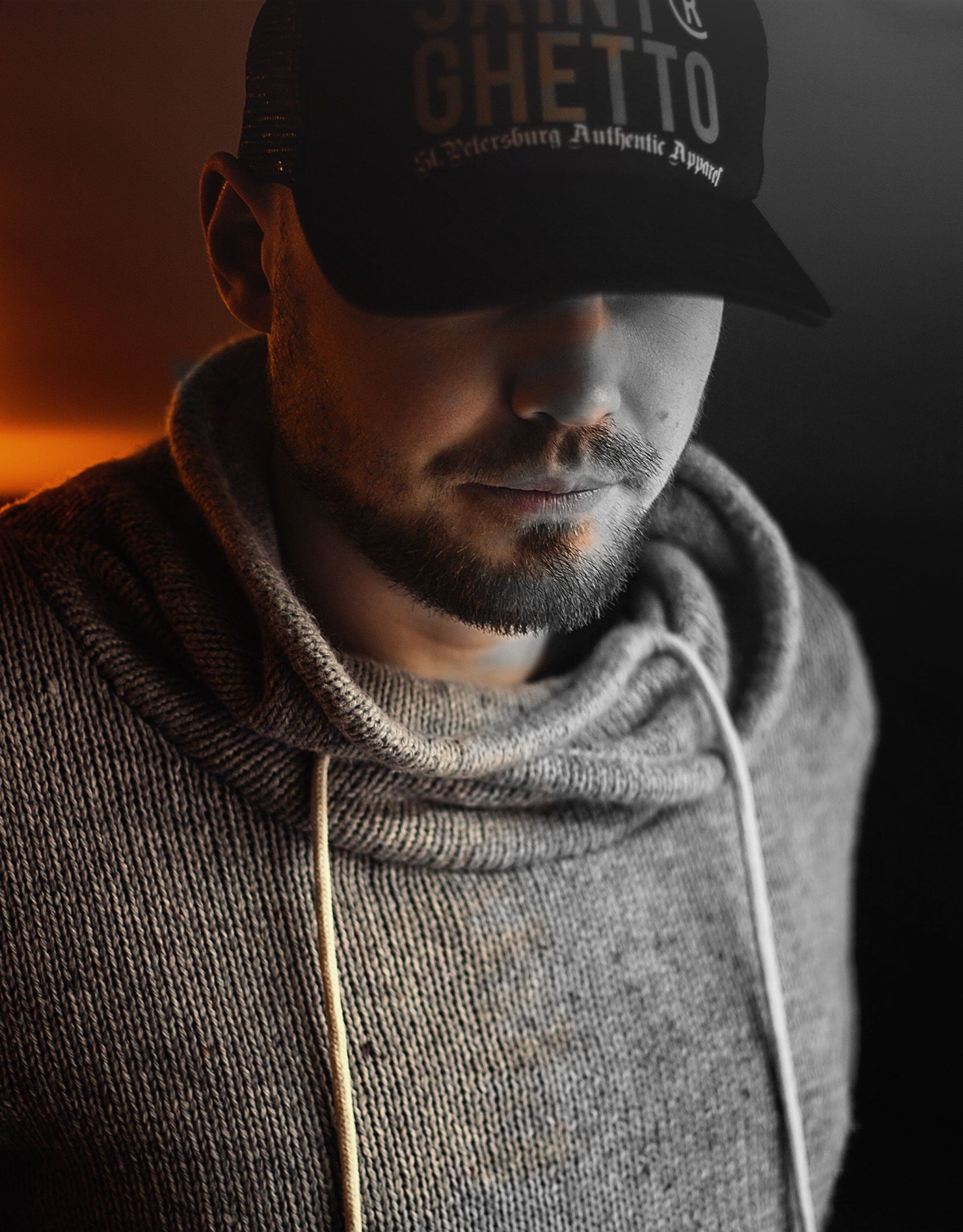 A man with a beard wearing a hat that says ghetto