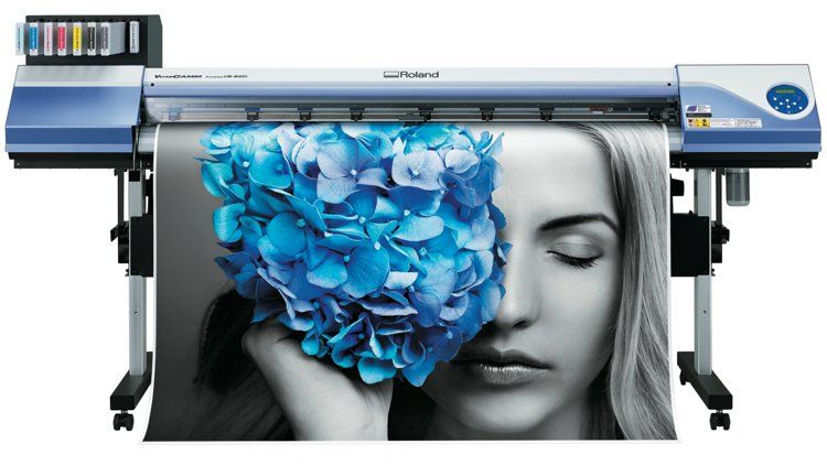 A large printer with a picture of a woman with blue flowers on her face