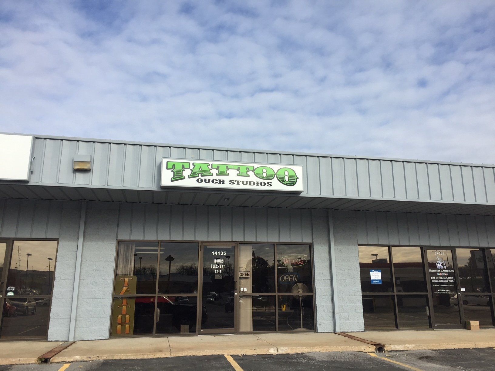 A building with a sign that says tattoo on it