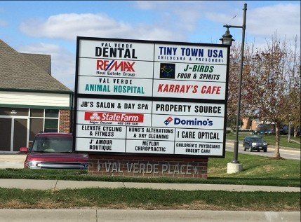 A sign for tiny town usa is in front of a building