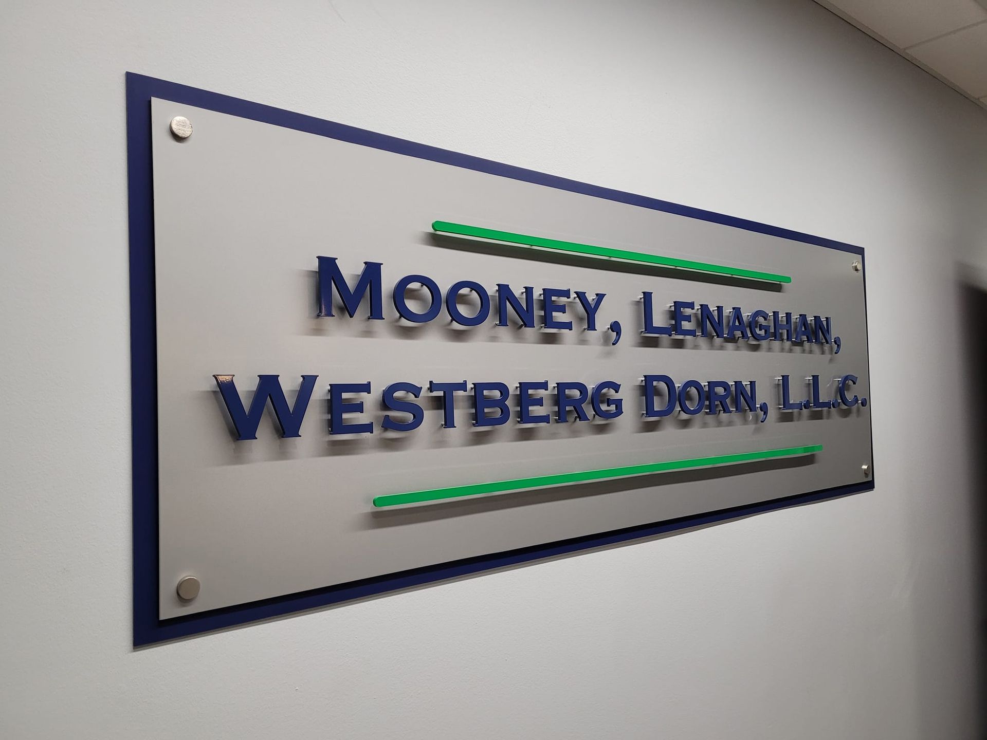 A sign on a wall that says mooney lemagnon westberg dorn llc