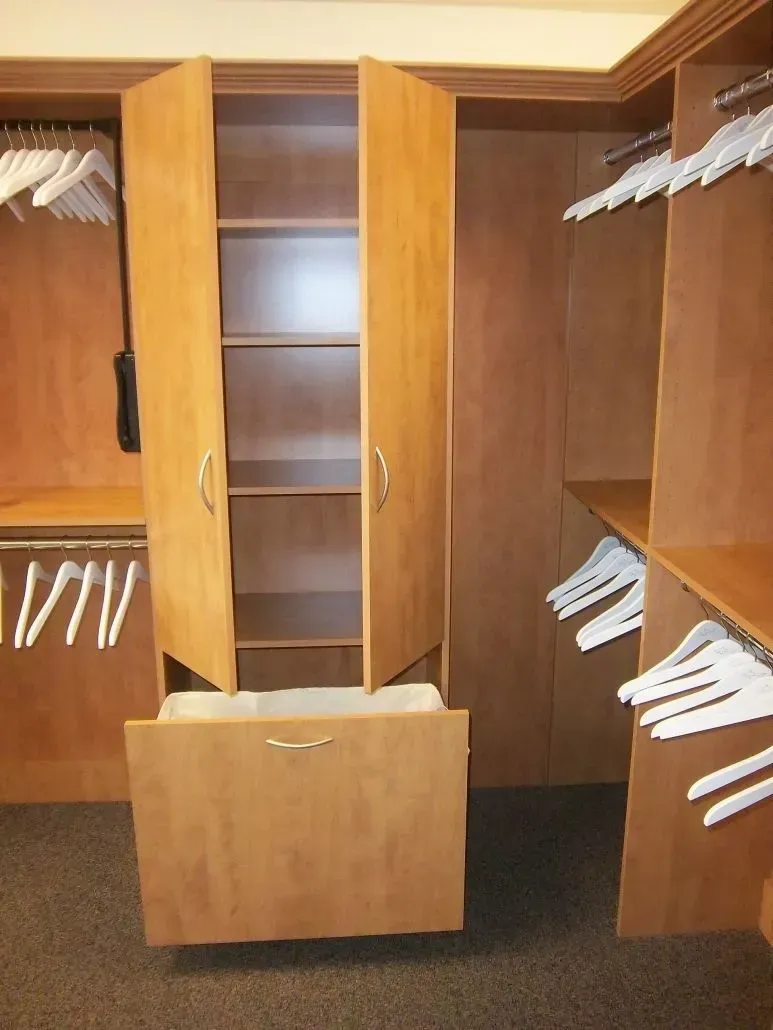 Wooden closet with open doors and shelves, and a pull-out drawer.