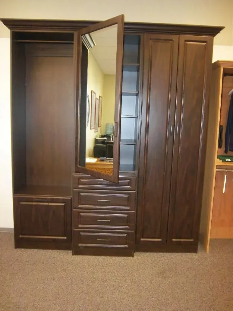 Dark brown wooden wardrobe with mirror and drawers; open and closed sections.
