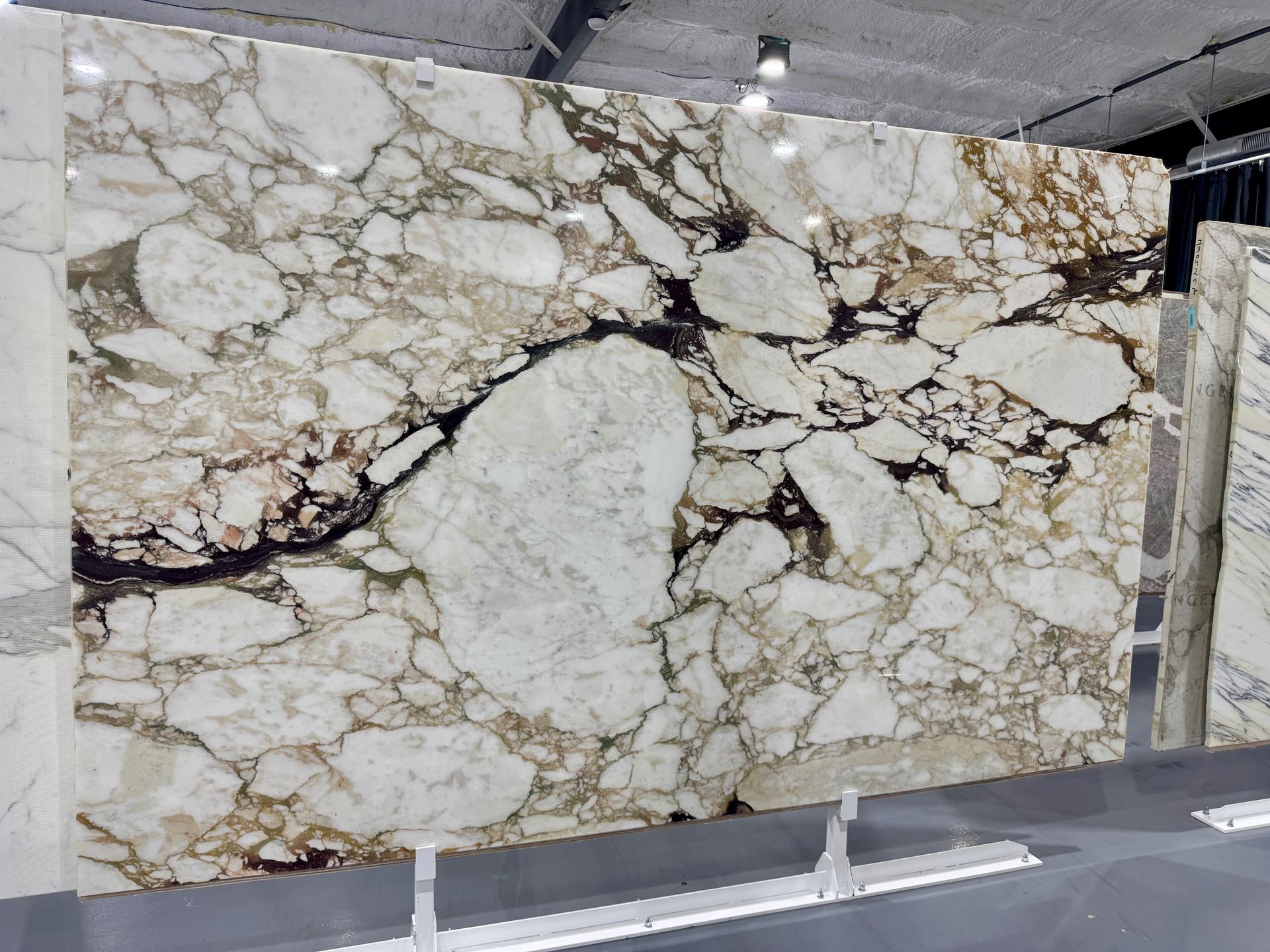 A large piece of marble is sitting on a shelf in a room.