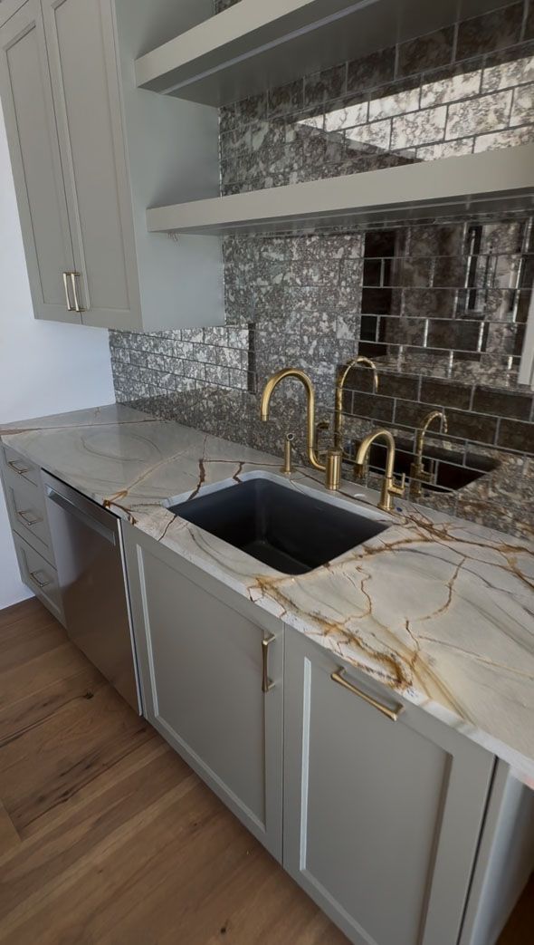 A kitchen with granite counter tops and a sink.