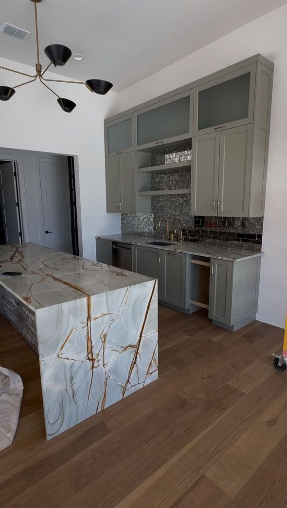 A kitchen with a large island in the middle of the room.