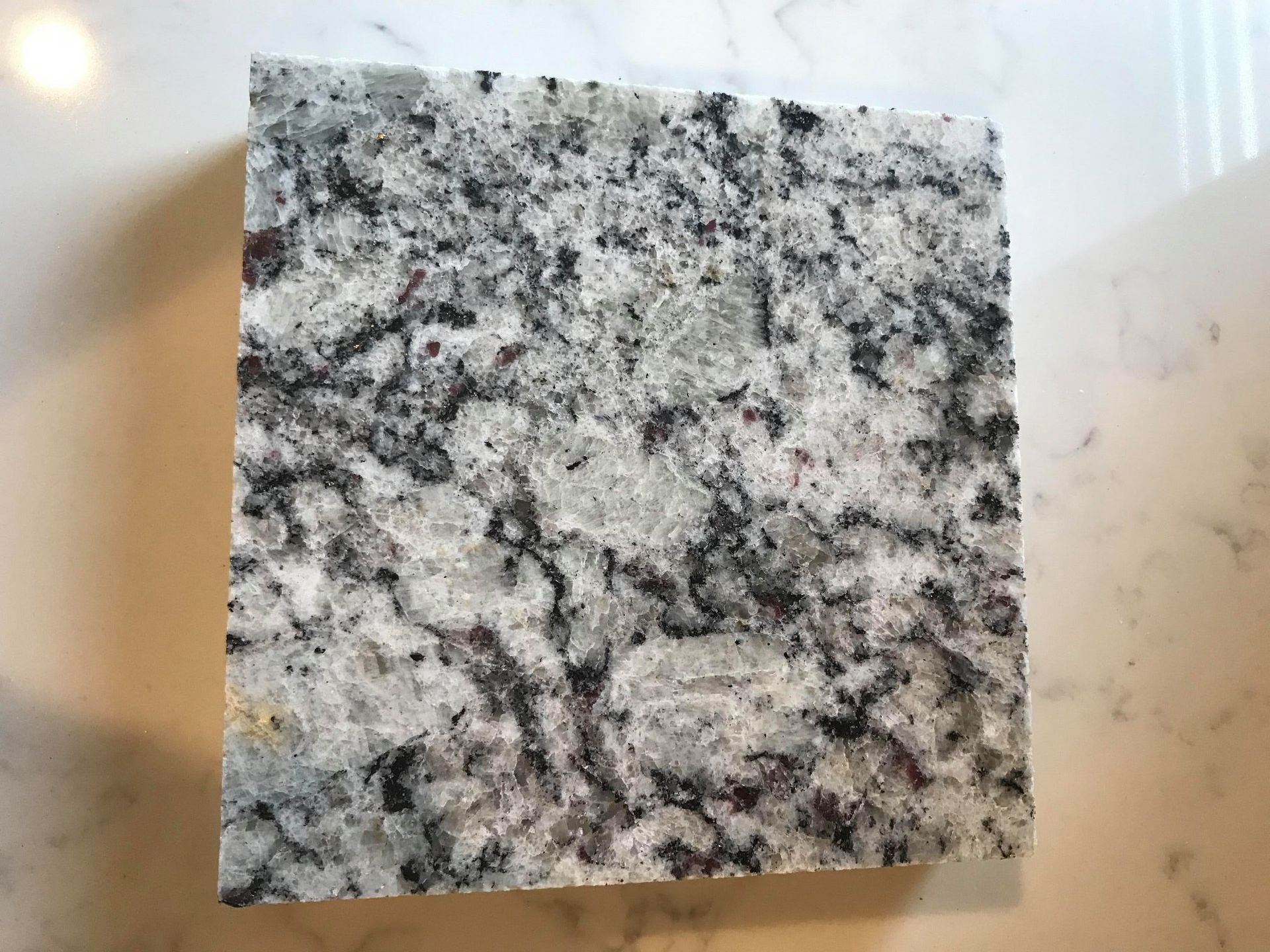 A piece of granite is sitting on top of a white counter.