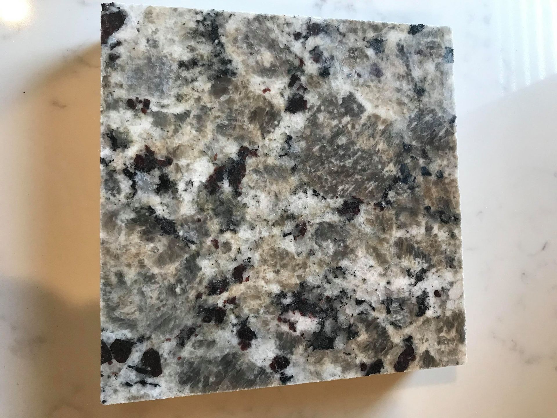 A piece of granite is sitting on top of a white counter.