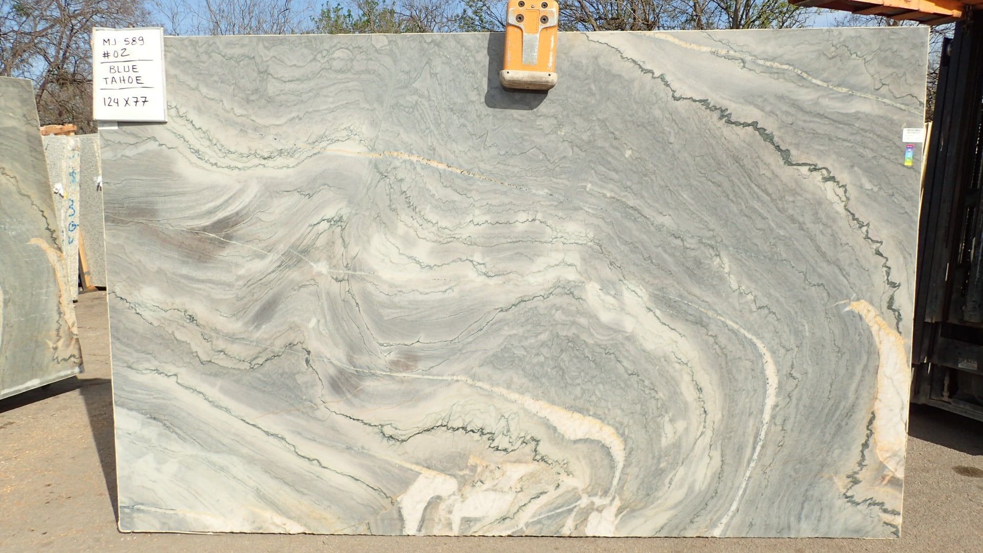 A large slab of granite is sitting on the ground