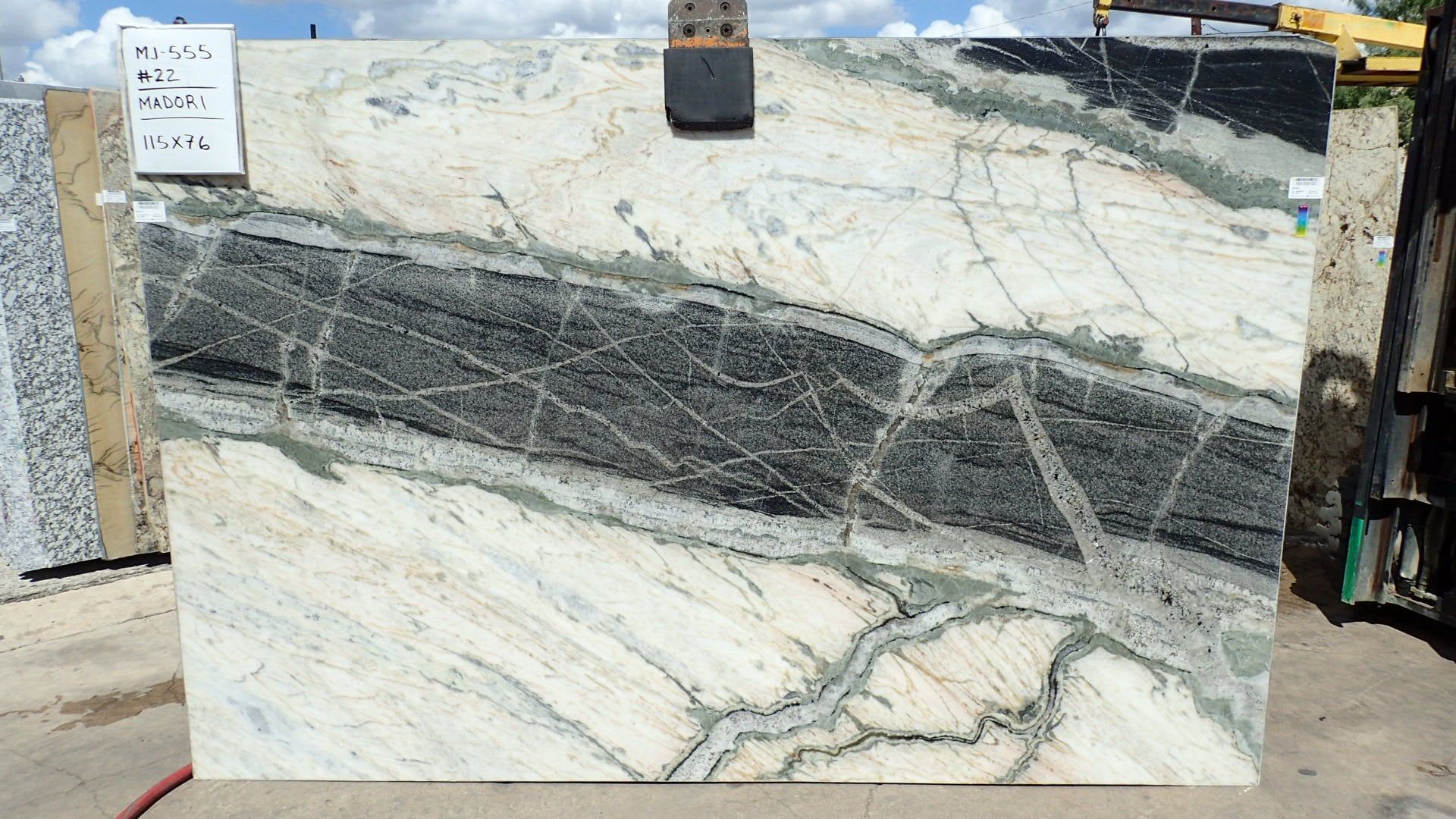 A large piece of marble is sitting on the ground.