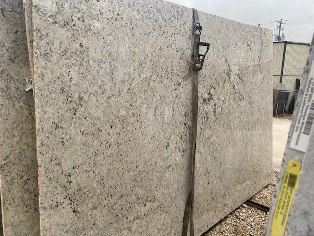 A stack of white granite slabs sitting on top of each other.