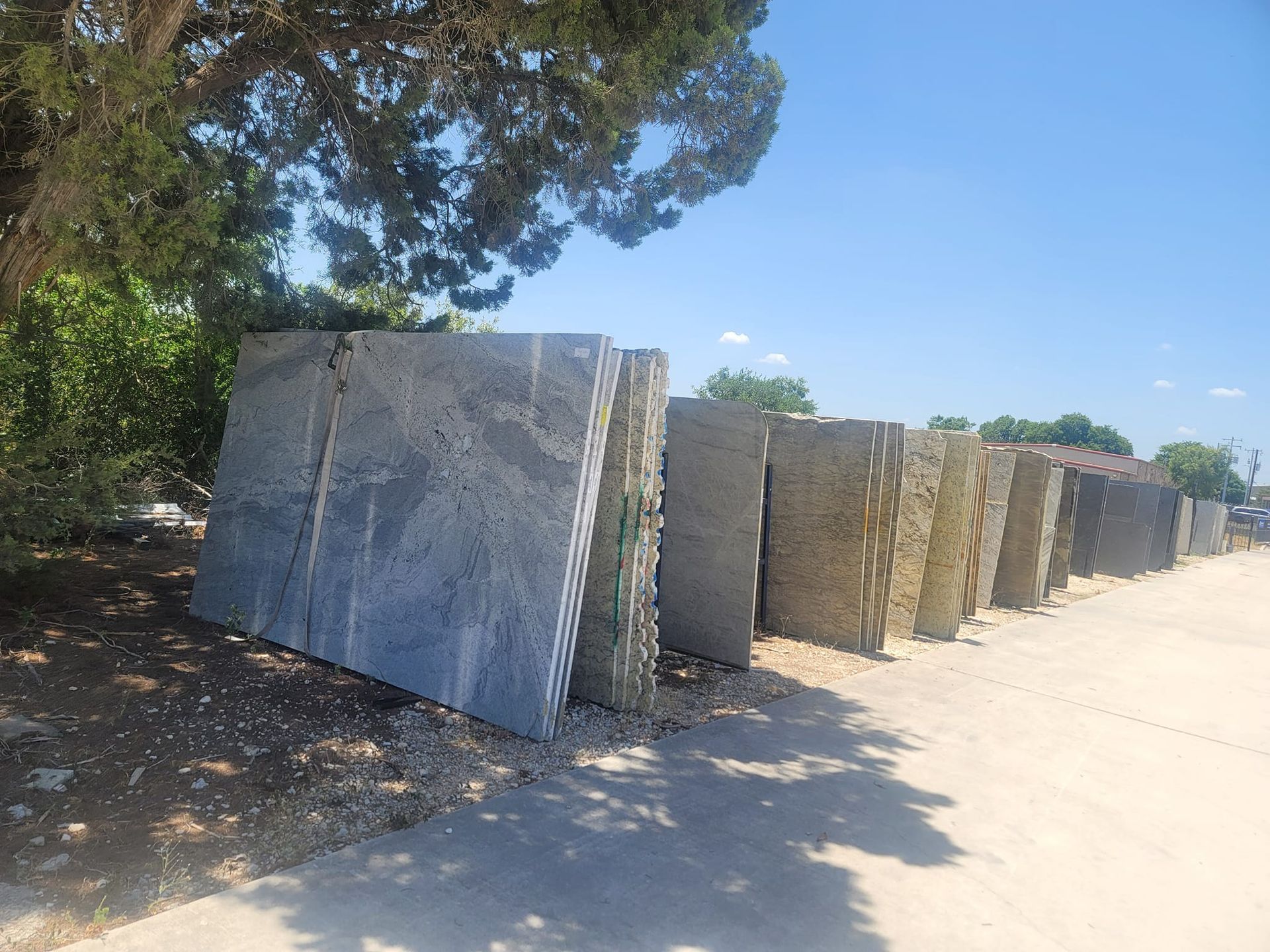 A row of concrete blocks are lined up on the side of a road.