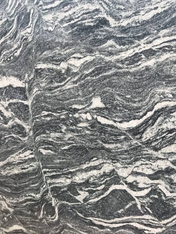 A close up of a black and white granite counter top.