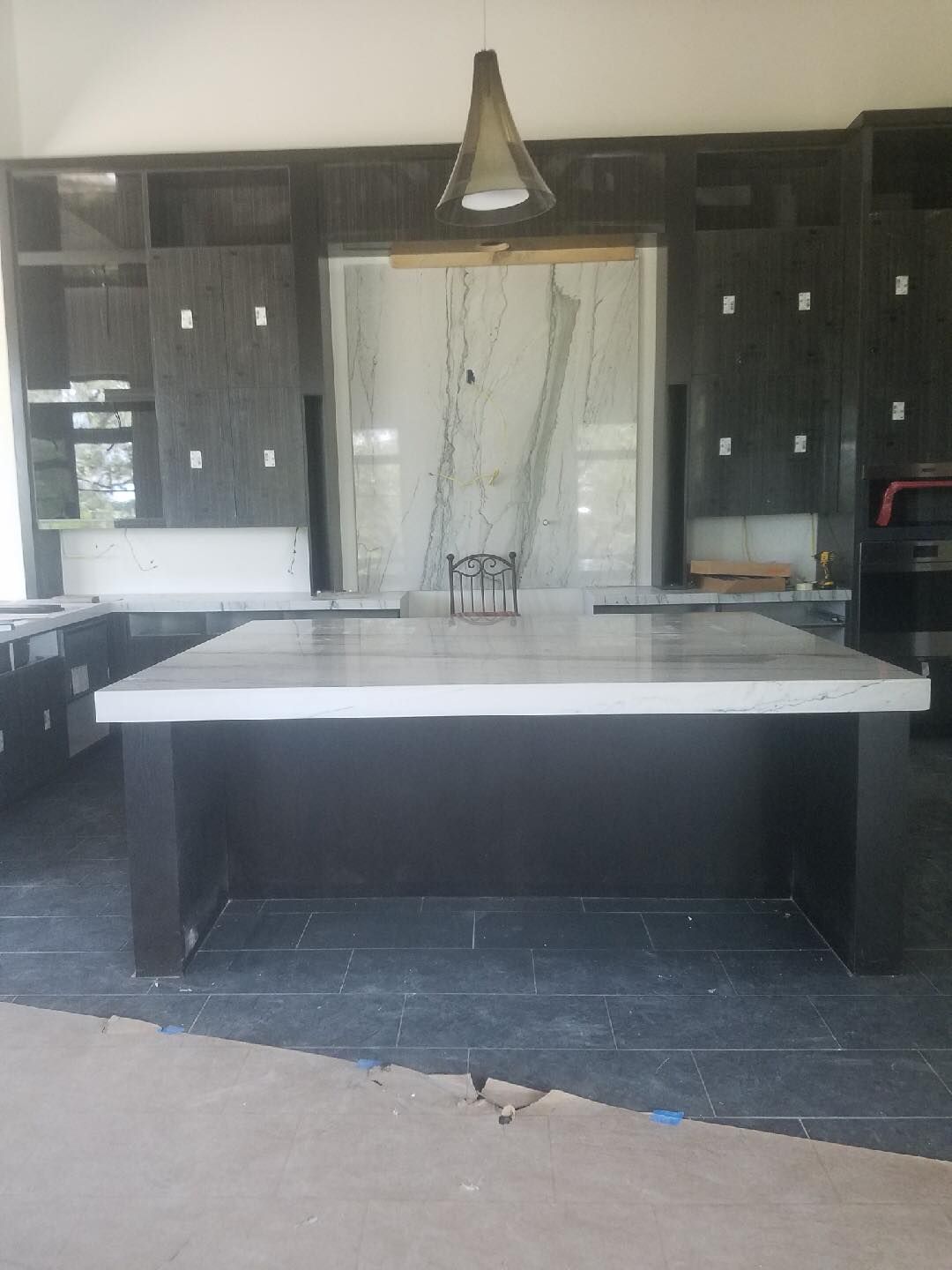 A kitchen with a large island in the middle of it.