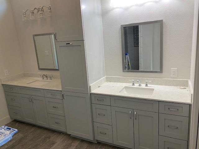 A bathroom with two sinks and a mirror.