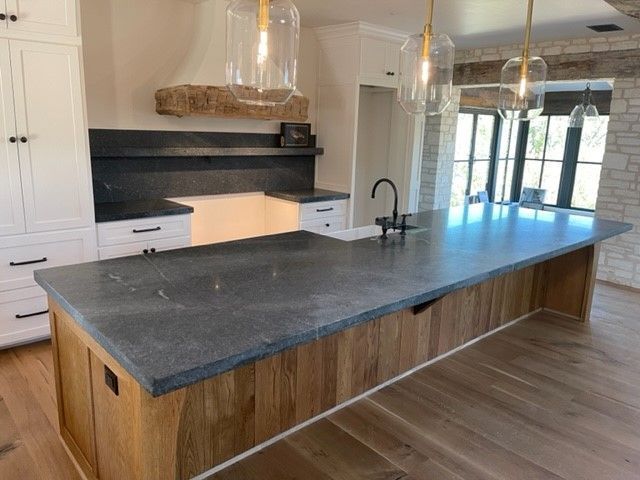 A kitchen with a large island and a sink.