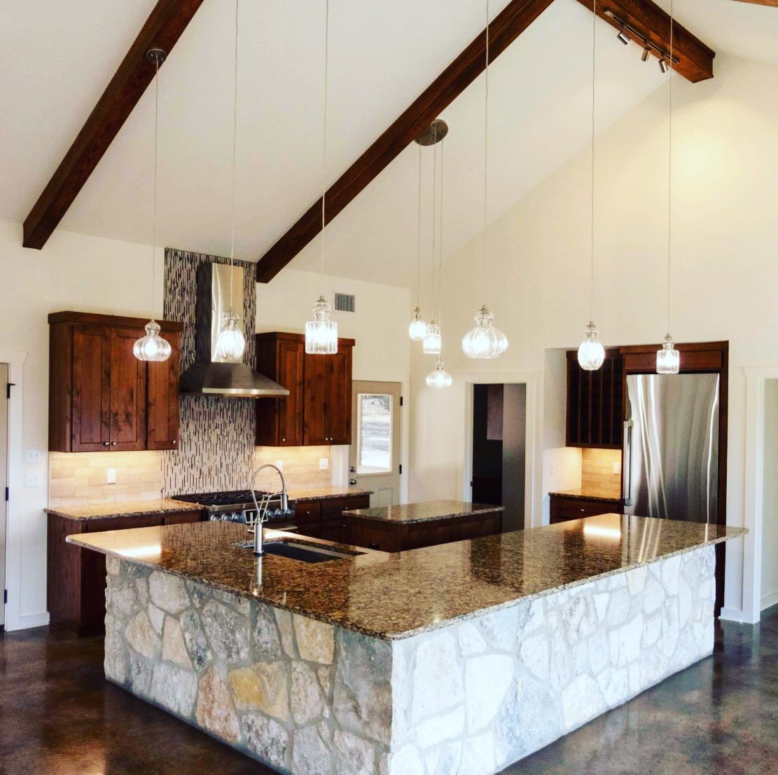 A kitchen with granite counter tops and stainless steel appliances