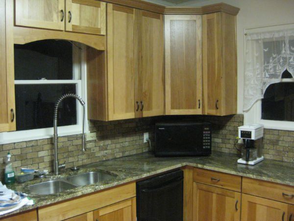 A kitchen with wooden cabinets and granite counter tops