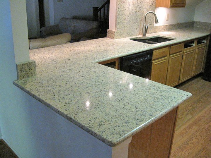 A kitchen with a granite counter top and a sink